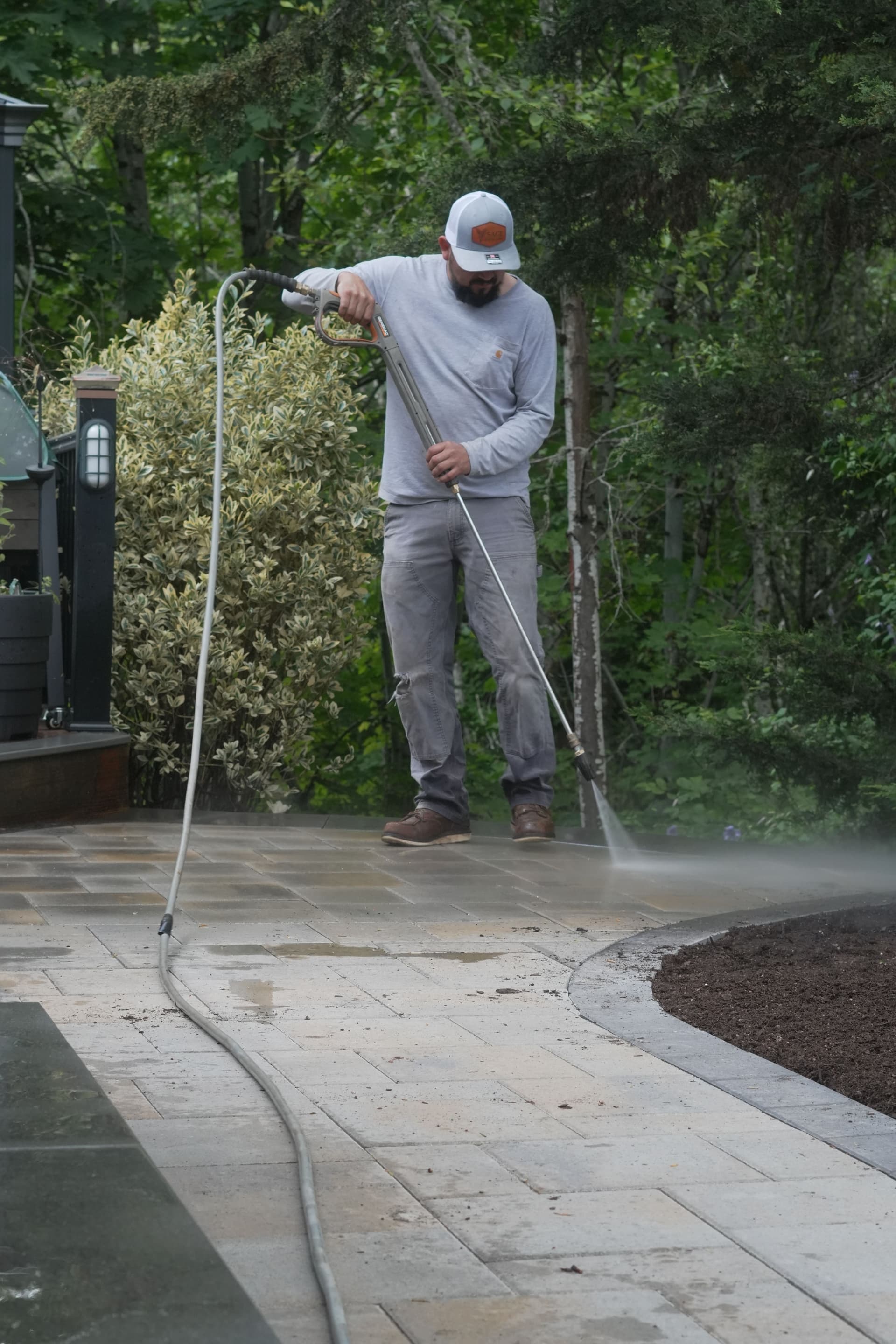 Paver Side Yard and Retaining Wall With Privacy Shrubs image
